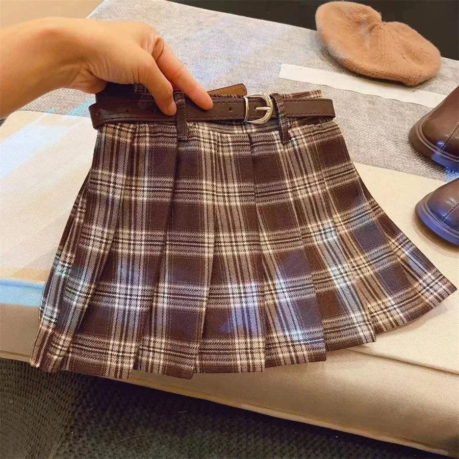 Girls' red and black plaid pleated A-line skirt on a hanger