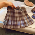 Girls' red and black plaid pleated A-line skirt on a hanger