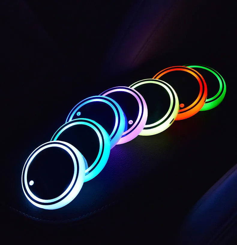 Colourful LED light-up car coaster in a vehicle cup holder, showing multiple light colours.