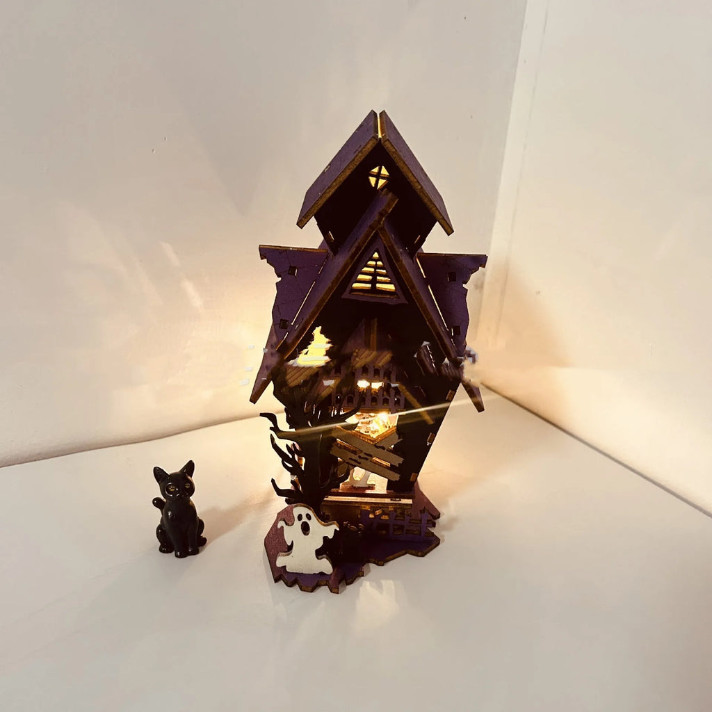 Unpainted DIY wooden haunted house Halloween decoration for use as a candlestick, shown next to a ruler for scale.