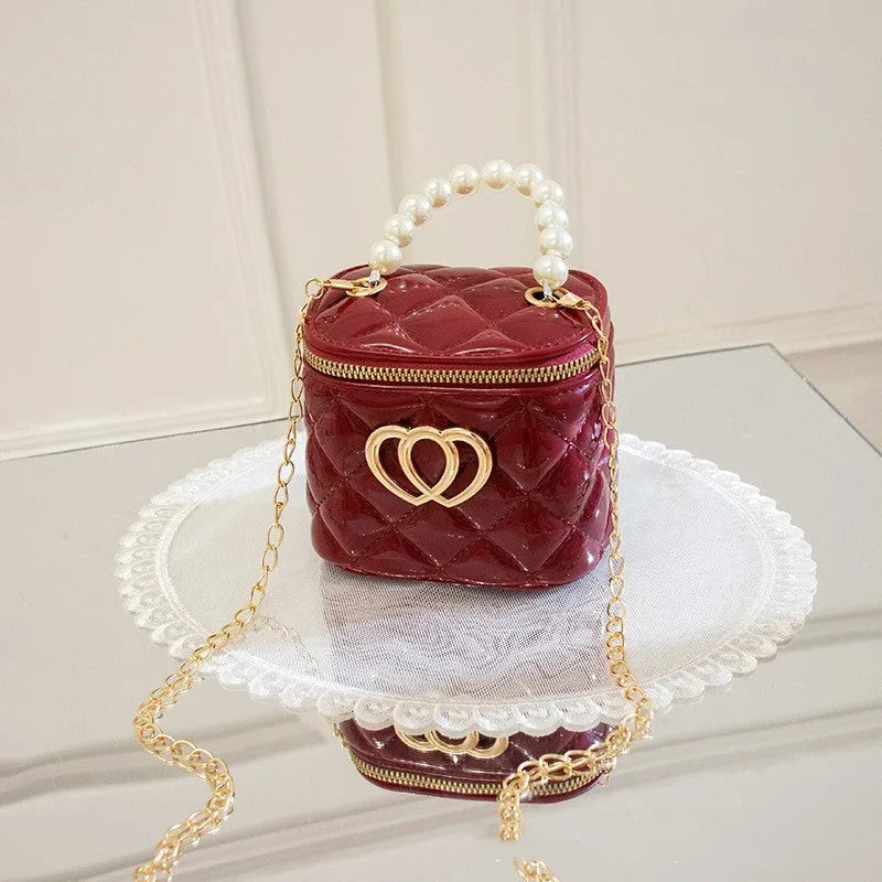 Women's PVC bucket gel bag with heart-shaped pattern in assorted colours.