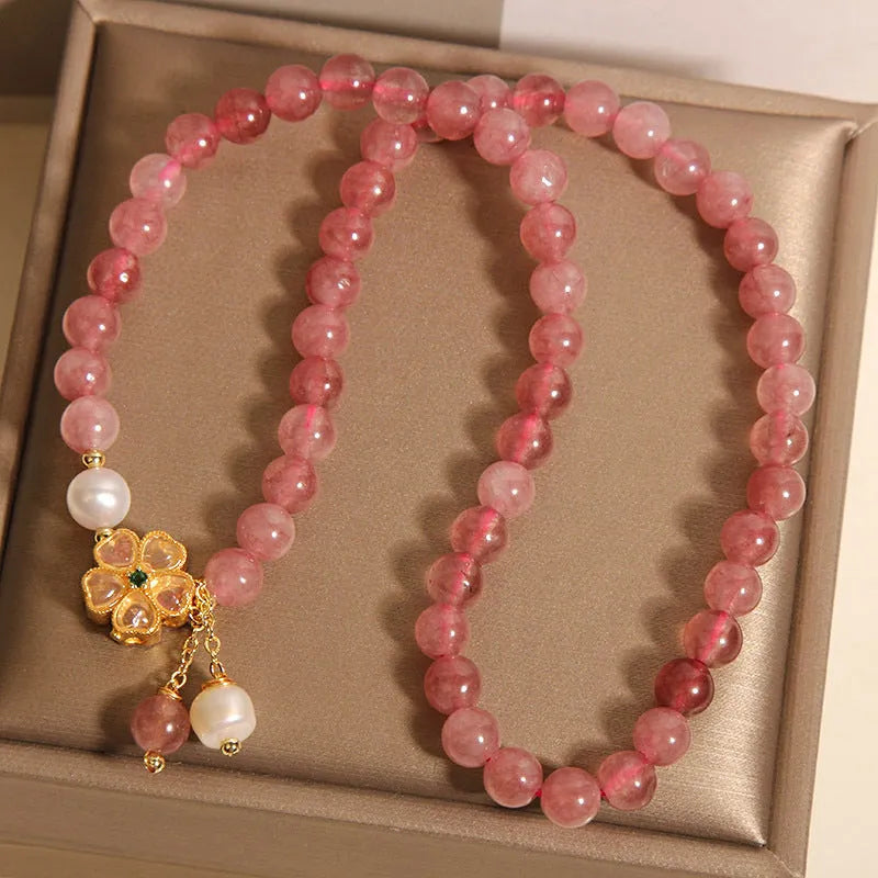 Women's double ring bracelet with strawberry quartz four-leaf clover charm and alloy inlay detailing