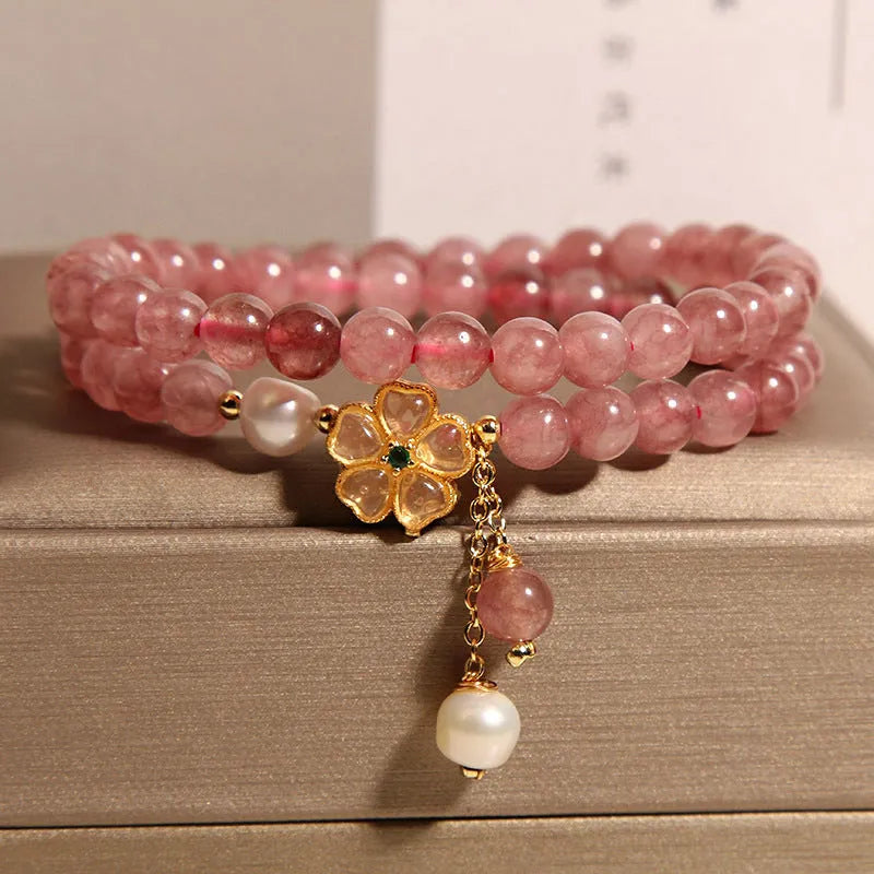 Women's double ring bracelet with strawberry quartz four-leaf clover charm and alloy inlay detailing