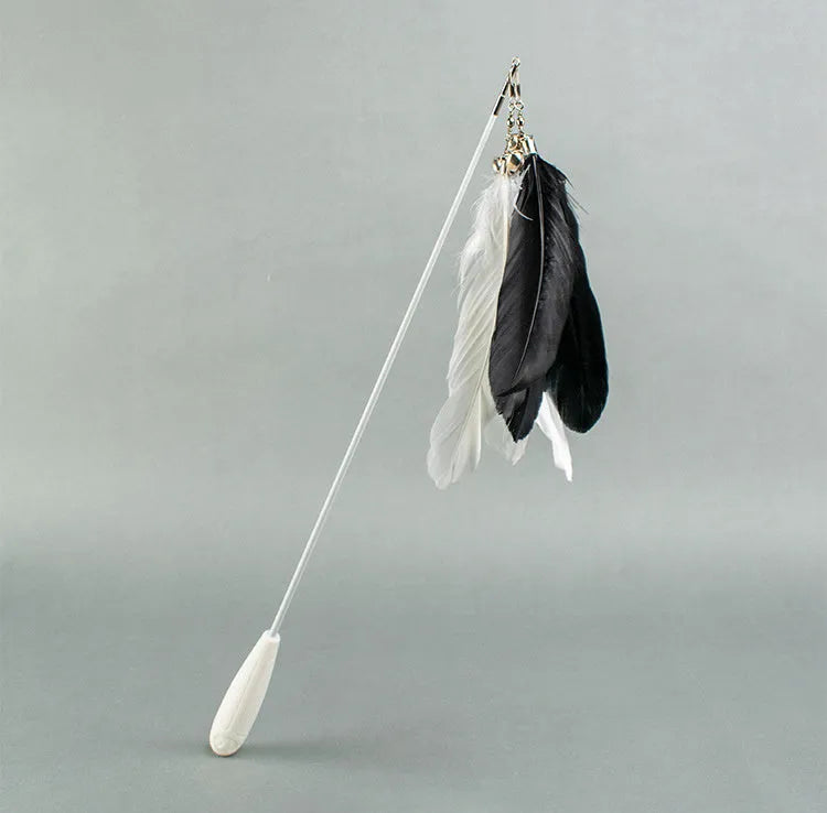 White telescopic cat fishing rod extended with goose feather lure and removable pen attachment