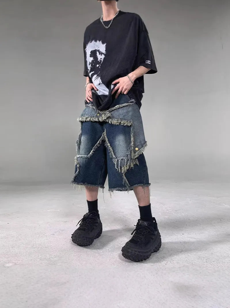 Blue men's denim shorts with a loose fit, frayed hem, and an embroidered five-pointed star on the leg.
